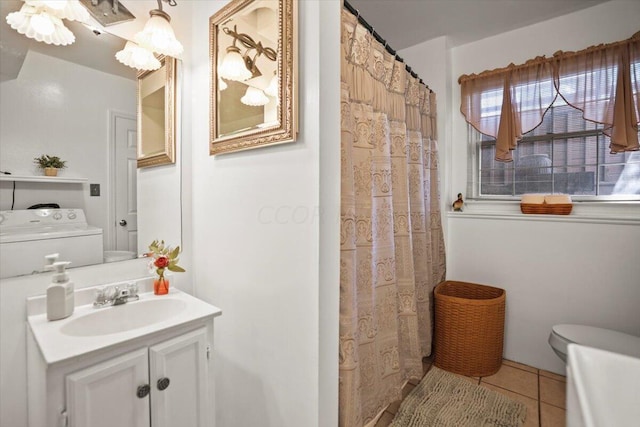 bathroom with vanity, tile patterned flooring, toilet, walk in shower, and washer / clothes dryer