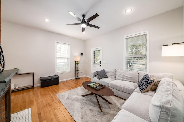 living room featuring ceiling fan and light hardwood / wood-style floors