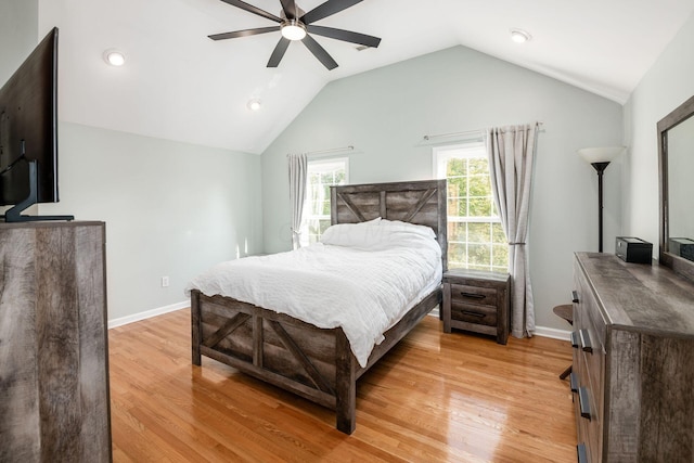 bedroom featuring ceiling fan, light wood-type flooring, and vaulted ceiling