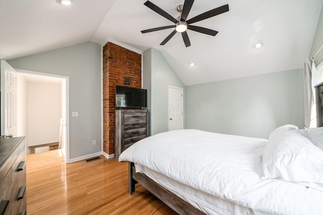 bedroom with light hardwood / wood-style floors, vaulted ceiling, and ceiling fan