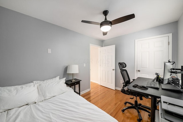 bedroom with ceiling fan and hardwood / wood-style floors