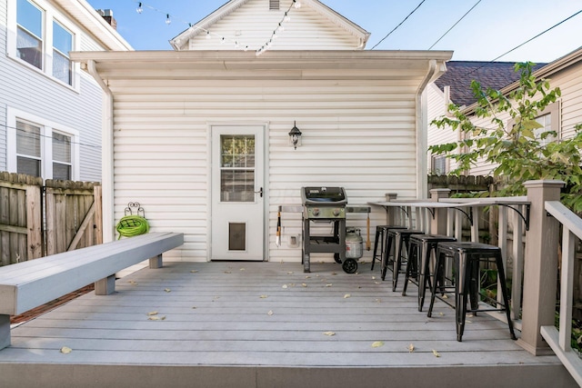 wooden deck featuring an outdoor bar and grilling area