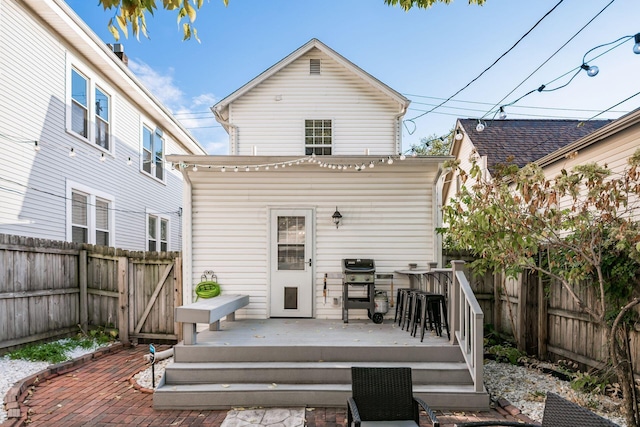 rear view of house with an outdoor bar and a wooden deck