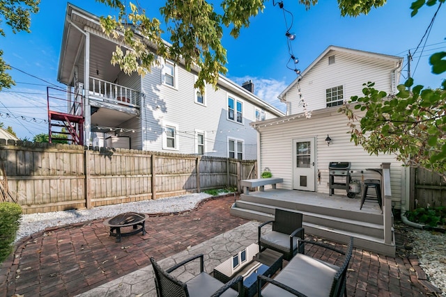 view of patio / terrace featuring grilling area, a deck, and an outdoor fire pit