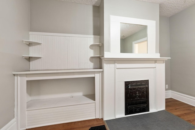 room details featuring a textured ceiling and hardwood / wood-style flooring