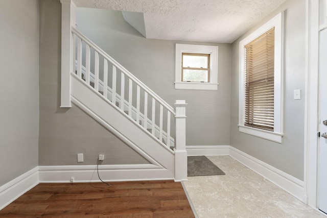 foyer with a textured ceiling and hardwood / wood-style flooring