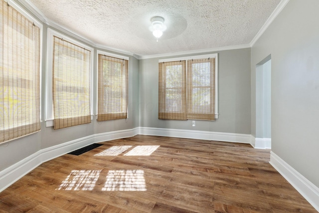 interior space with hardwood / wood-style flooring, crown molding, and a textured ceiling