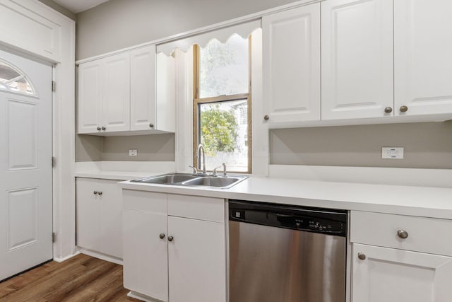 kitchen featuring white cabinets, stainless steel dishwasher, dark wood-type flooring, and sink