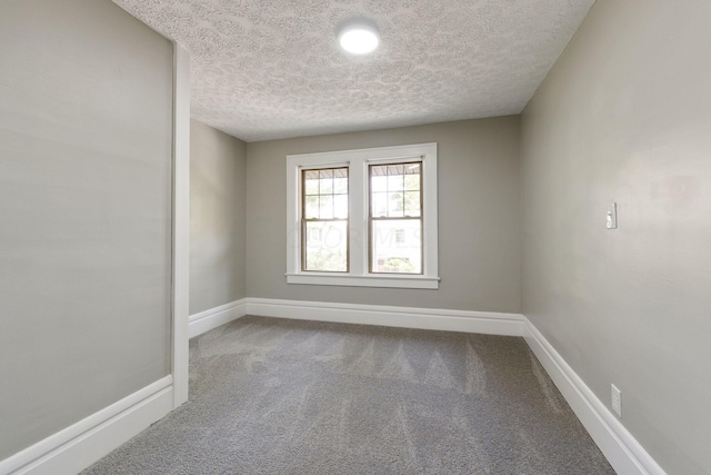 empty room featuring carpet and a textured ceiling