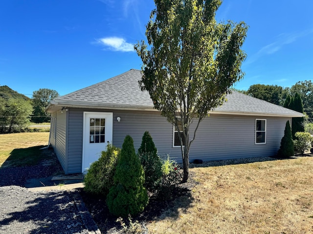 view of side of home featuring a lawn