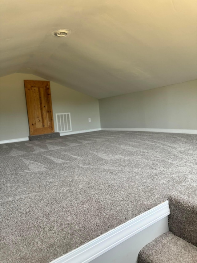 bonus room featuring carpet flooring and vaulted ceiling