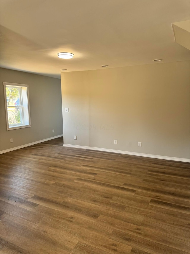 empty room featuring dark wood-type flooring