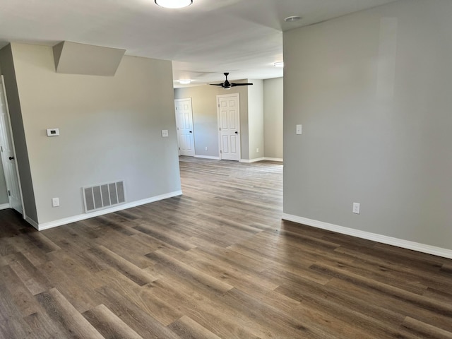 spare room with ceiling fan and dark wood-type flooring