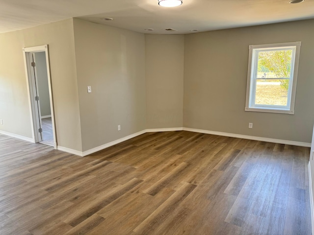 spare room with wood-type flooring