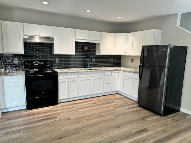 kitchen featuring black appliances, light wood-type flooring, white cabinetry, and sink