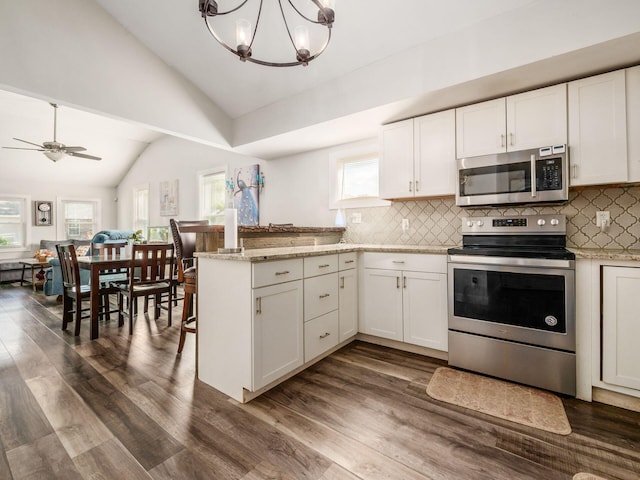 kitchen with ceiling fan with notable chandelier, white cabinetry, stainless steel appliances, and dark wood-type flooring