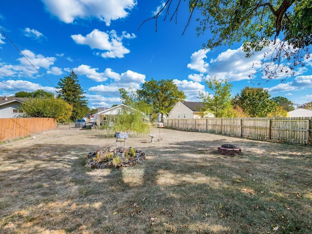 view of yard with a fire pit