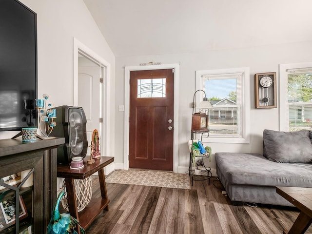 entrance foyer with hardwood / wood-style floors and vaulted ceiling