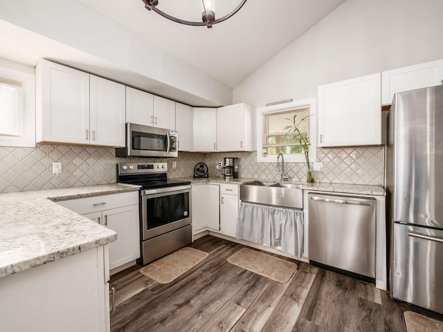 kitchen featuring sink, a wealth of natural light, dark hardwood / wood-style flooring, white cabinetry, and stainless steel appliances