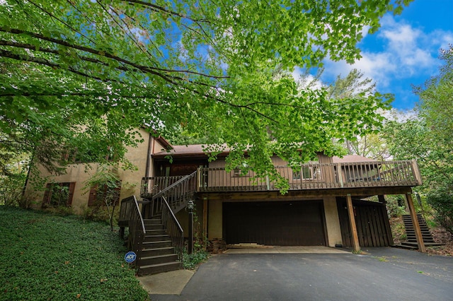 view of front of property featuring a garage and a wooden deck