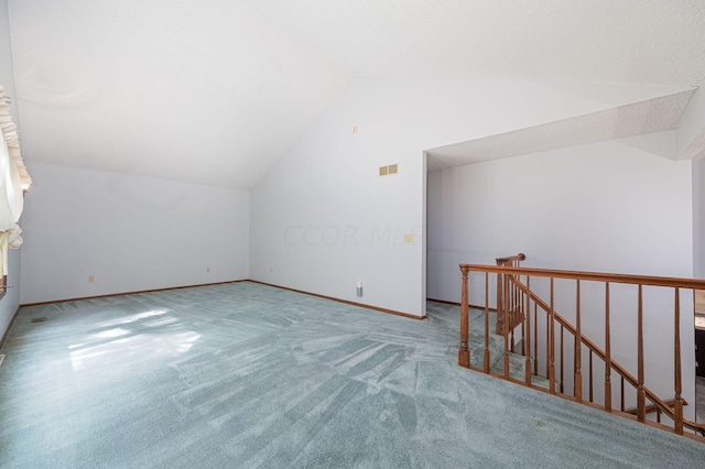 bonus room featuring carpet and vaulted ceiling