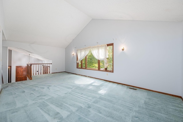 additional living space featuring carpet flooring and lofted ceiling