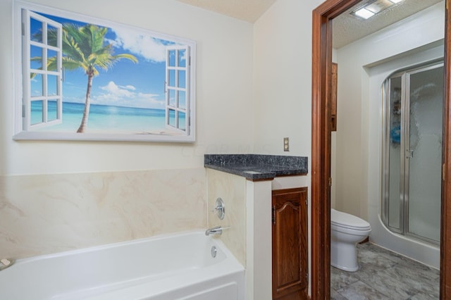 bathroom with a textured ceiling, toilet, and separate shower and tub