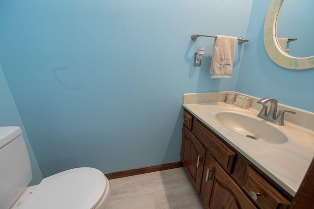 bathroom featuring tile patterned floors, vanity, and toilet