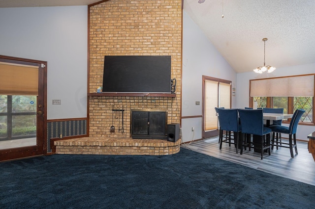 living room featuring a wealth of natural light, a fireplace, and a textured ceiling