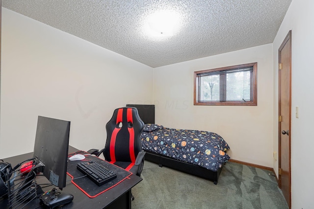 bedroom with carpet floors and a textured ceiling