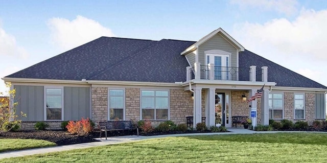 4843 Edison St, Hilliard, OH 43026 - view of front facade with a balcony, a front yard, roof with shingles, and stone siding
