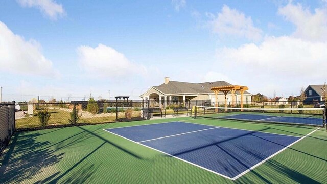 view of tennis court featuring fence