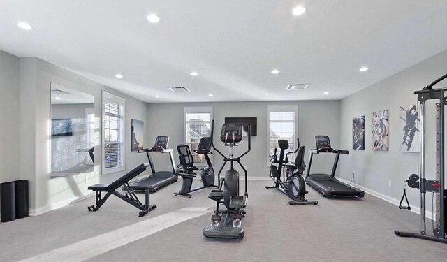 workout area featuring recessed lighting, a healthy amount of sunlight, and visible vents