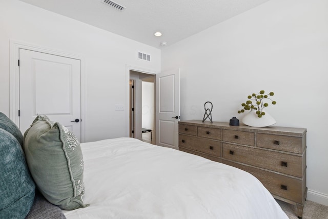 bedroom with carpet, visible vents, and baseboards