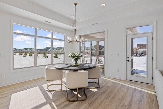 dining space featuring light wood-style flooring, a notable chandelier, recessed lighting, baseboards, and ornamental molding