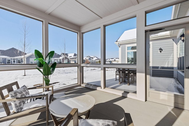 sunroom with a residential view and a wealth of natural light