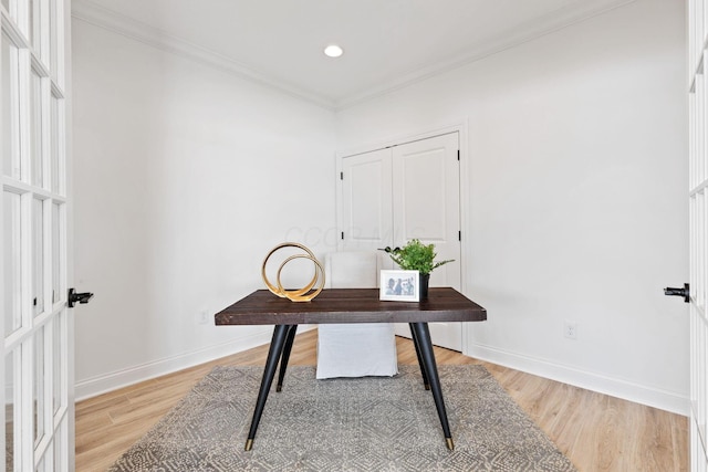 office featuring light wood-style floors, baseboards, crown molding, and recessed lighting