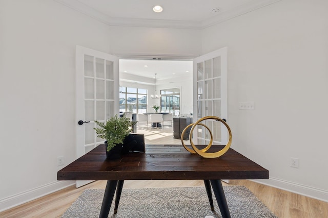 office space featuring ornamental molding, recessed lighting, light wood-style flooring, and baseboards