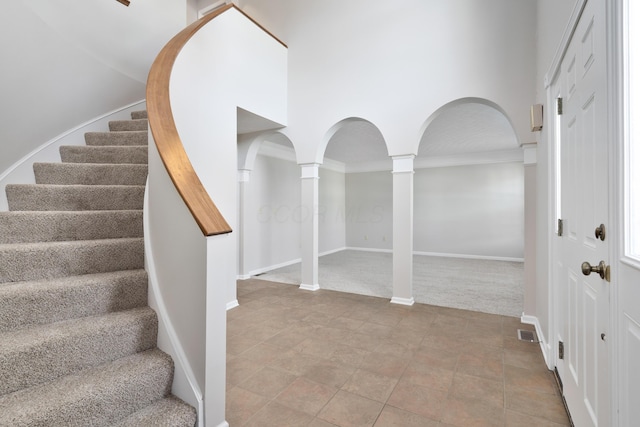 interior space with decorative columns and crown molding