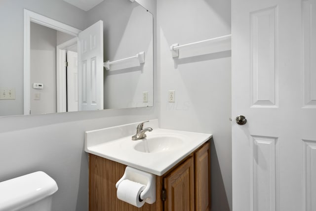 bathroom with vanity and toilet