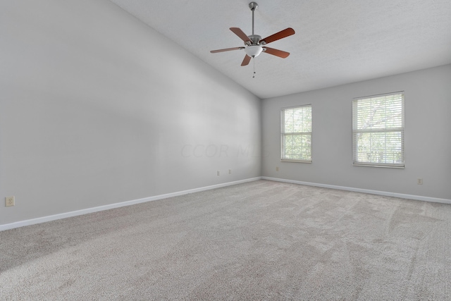 empty room with ceiling fan, light colored carpet, and high vaulted ceiling