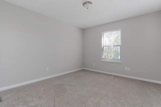 unfurnished room featuring carpet