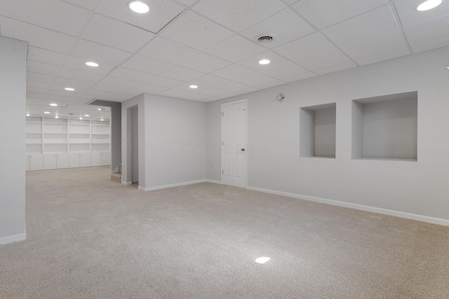 empty room with light carpet and a drop ceiling