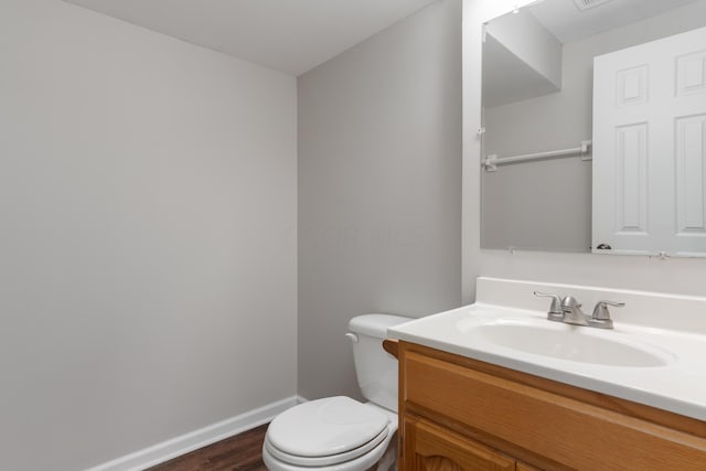 bathroom featuring hardwood / wood-style floors, vanity, and toilet