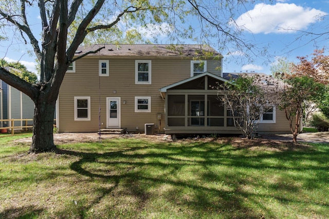 back of house featuring a sunroom, a yard, and central AC unit