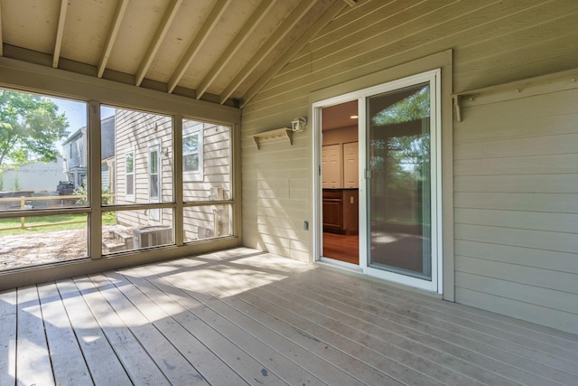 unfurnished sunroom featuring vaulted ceiling