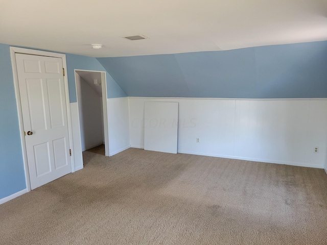 bonus room featuring carpet flooring and lofted ceiling