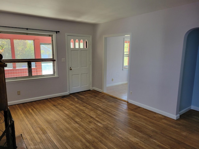 859 Gladden Rd, Grandview Heights, OH 43212 - foyer entrance featuring arched walkways, hardwood / wood-style floors, and baseboards