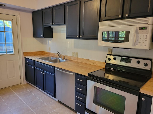 859 Gladden Rd, Grandview Heights, OH 43212 - kitchen with appliances with stainless steel finishes, a sink, decorative backsplash, and light tile patterned floors