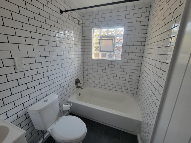 859 Gladden Rd, Grandview Heights, OH 43212 - full bathroom with tile walls, toilet, tile patterned flooring, and shower / washtub combination